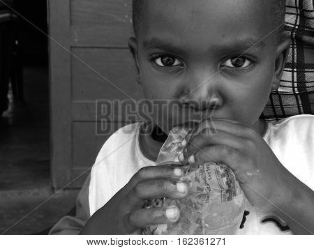 Young Child from Ghana, West Africa drinking water