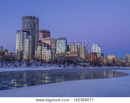 CALGARY, CANADA - DEC 17: Calgary's skyline at sunrise on a cold winter day on December 17, 2016 in Calgary, Alberta. Calgary is home to many oil companies. The Bow River is visible.