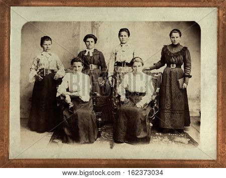 KISLOVODSK,RUSSIA - CIRCA 1912:Retro picture of woman. Group of family in the photographer's parlor. Vintage photo from 1912 with original film grain, blur and scratches.