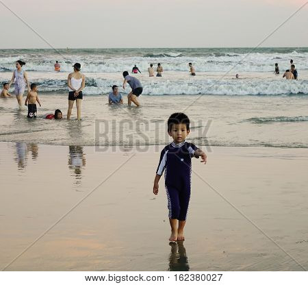 People Playing On The Beach At Sunset