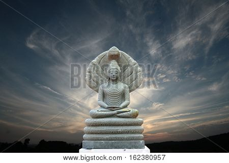 Beautiful Stone Buddha Image Covered With Seven Heads ,evening Sky.