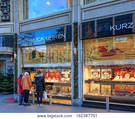 Zurich, Switzerland - 19 December, 2016: people looking at windows of Kurz store on Bahnhofstrasse street, decorated for Christmas. Bahnhofstrasse is Zurich's main downtown street and one of the world's most expensive and exclusive shopping avenues.