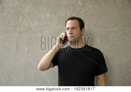 Man having a concerning phone call on his smart phone.