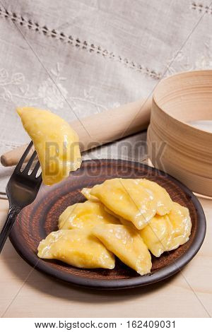 Close Up View Of Boiled Varenyky Or Dumpling With Cottage Cheese Or Curd On Metal Fork. Fresh Boiled