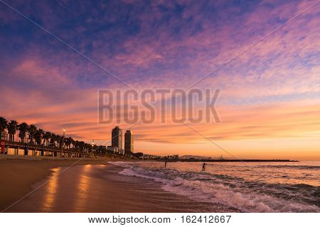 Surfers In Barcelona Beach