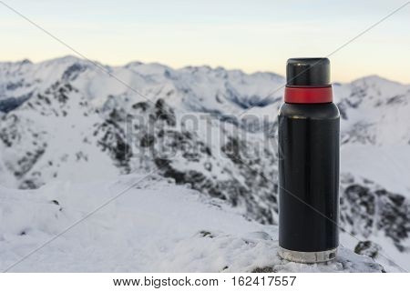 Thermos Of Hot Tea In The Mountains.