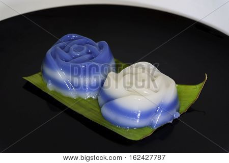 Thai traditional dessertKhanom Chan on banana leaf using flower mold