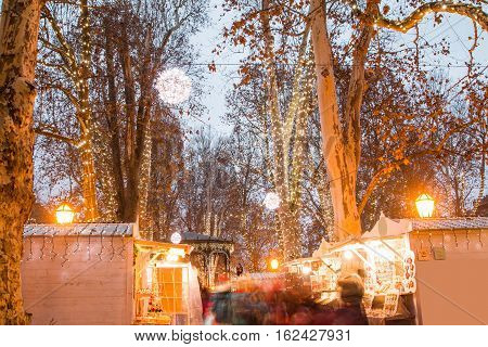 Advent time in the center of Zagreb, Croatia, people gathering in Zrinjevac park with food stands, blurred motion, unrecognizable people
