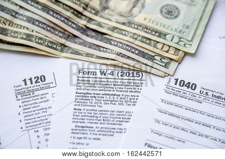 Tax Form W4 1120 1040 with dollar