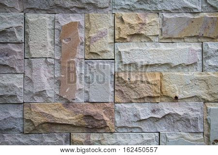 Stone wall from small pieces in gray color
