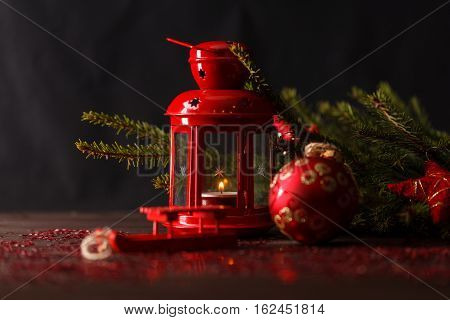 Christmas decoration lantern with burning candle on table