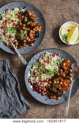 Moroccan aubergine and chickpea stew and bulgur. Healthy vegetarian lunch. On a wooden table top view. Flat lay