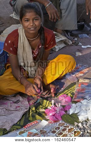 AHMADABAD, INDIA - OCTOBER 31, 2007: Women selling colorful paint powder for the Hindu festival of Holi at a street market in Ahmadabad, Gujarat, India.