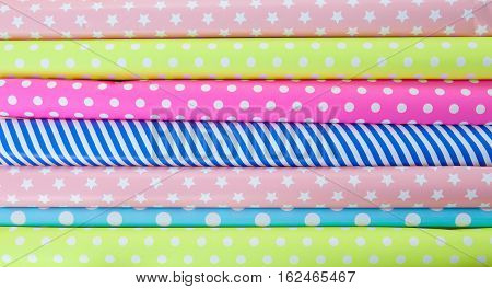 Cheerful background made from rolls of colorful wrapping paper
