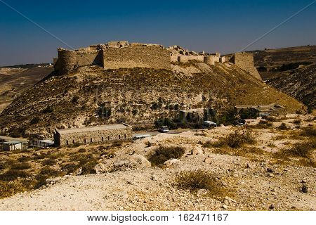 Photo of the Remains ancient impressive castle on mountain. Shobak crusader fortress. Castle walls. Travel concept. Jordan architecture and attraction