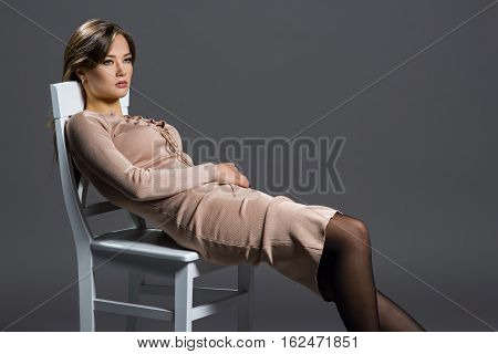 Portrait of a beautiful woman on a gray background