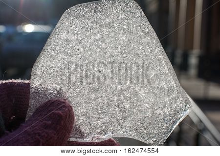 a piece of ice in the sun, unusually shaped piece of ice