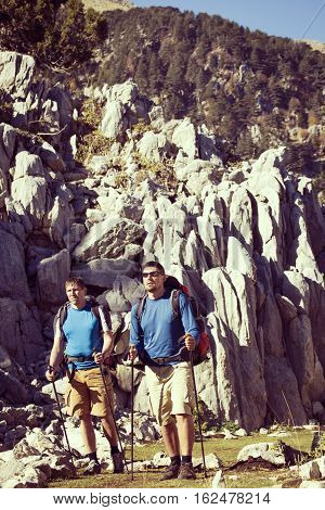 Summer hiking in the mountains with a backpack .