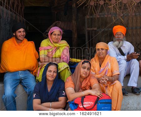 MANIKARAN, INDIA. 4 June 2009: Rural residents in daily life.  The family of Sikh pilgrims on vacation at the Sikh Gurdwara. Manikaran is a sacred pilgrimage centre for Sikhs, district Kullu in Himachal Pradesh, India.