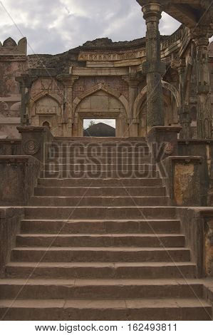 MANDU, INDIA - NOVEMBER 17, 2008: Steps leading to the Malik Mughith's Mosque inside the hilltop fortress town of Mandu in Madyha Pradesh, India. Built circa 1432 by Malik Mughith.