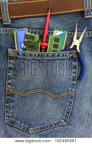 set of PC service tools in a back pocket of a blue denim jeans