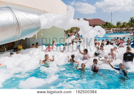 Cayo Coco island, Memories Carib hotel, July 2, 2016, amazing beautiful, gorgeous view of happy smiling joyful people relaxing and enjoying their time in swimming pool foam party on sunny day