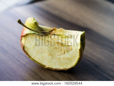 the dried-up apple on a wooden board can be used for design