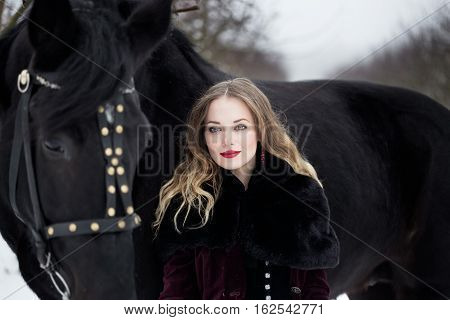 Girl In Dark Clothes With A Black Horse
