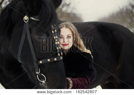 Girl In Dark Clothes With A Black Horse