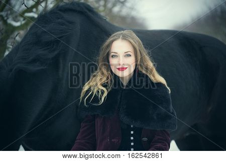 Girl In Dark Clothes With A Black Horse