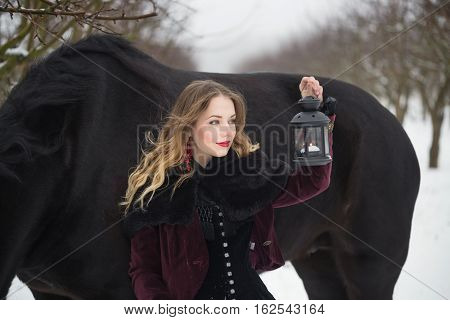 Girl In Dark Clothes With A Black Horse