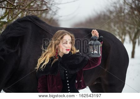 Girl In Dark Clothes With A Black Horse