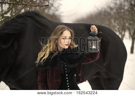Girl In Dark Clothes With A Black Horse