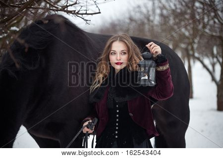 Girl In Dark Clothes With A Black Horse