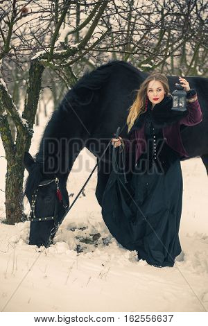 Girl In Dark Clothes With A Black Horse
