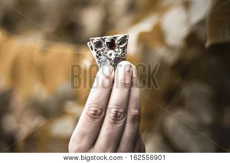 Hand of a girl holding hair pin.