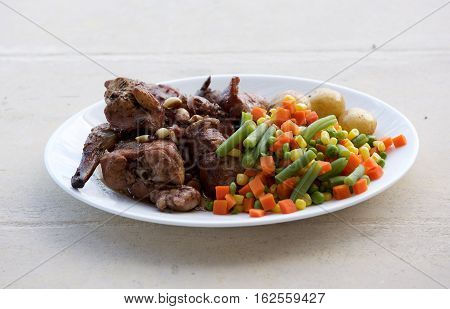Traditional maltese food - rabbit with fresh vegetables. Malta. Fenek