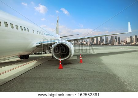 passenger plane parking in airport runway with urban scene background