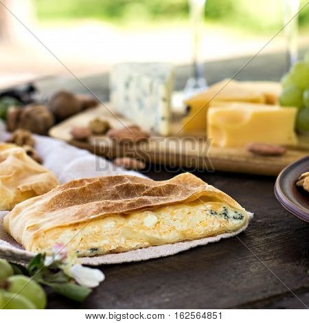 Сheese pie strudel with cheese cheese pie 4. Wine grapes nuts cheese blue cheese and coffee. dinner lunch romantic date picnic eating on nature.