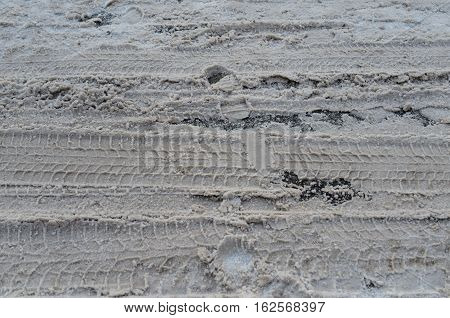 Dirty wet snow on the road in the city urban background