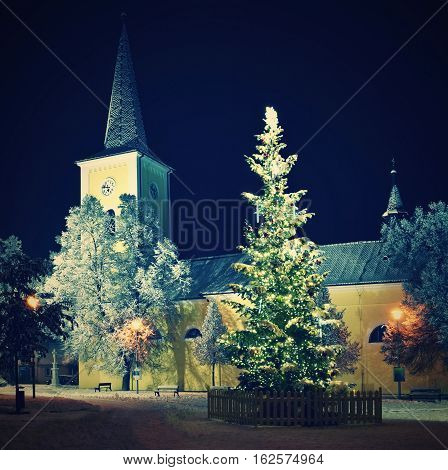 Beautiful Night Winter Photo Christmas Tree With Church And Snow.