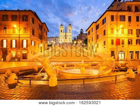 Spanish Steps with boat fountain illuminated at blue night, Rome, Italy