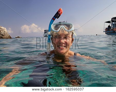 woman snorkeling in the seanear the the island