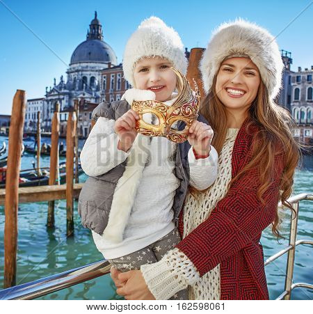 Mother And Child Travellers Holding Venetian Mask, Venice