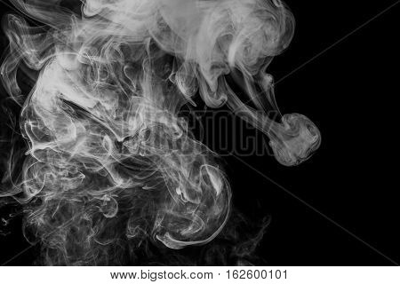 Abstract smoke Weipa. Personal vaporizers fragrant steam. The concept of alternative non-nicotine smoking. White smoke on a black background. E-cigarette. Evaporator. Taking Close-up. Vaping.