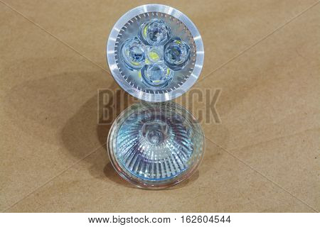 Halogen and led bulb isolated on craftool background