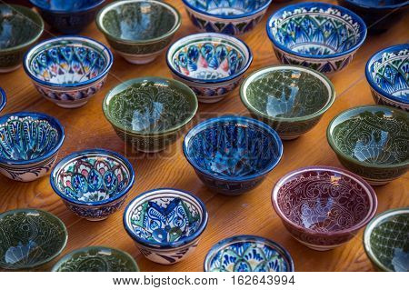 Rows of cups with traditional uzbekistan ornament on a street market of Bukhara Uzbekistan Central Asia. Silk Road