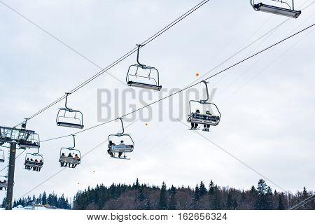 BUKOVEL, UKRAINE - December 17, 2016 : Skiers on a cable car in Bukovel. Bukovel is the most popular ski resort in Ukraine. Ski season and Winter sports concept