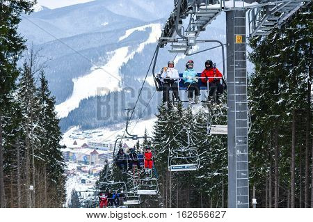 BUKOVEL, UKRAINE - December 17, 2016 : Skiers on a cable car in Bukovel. Bukovel is the most popular ski resort in Ukraine. Ski season and Winter sports concept