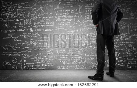 Bottom view of businessman or teacher and sketches at blackboard